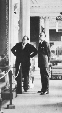 Dimbleby and a tall man look at a painting