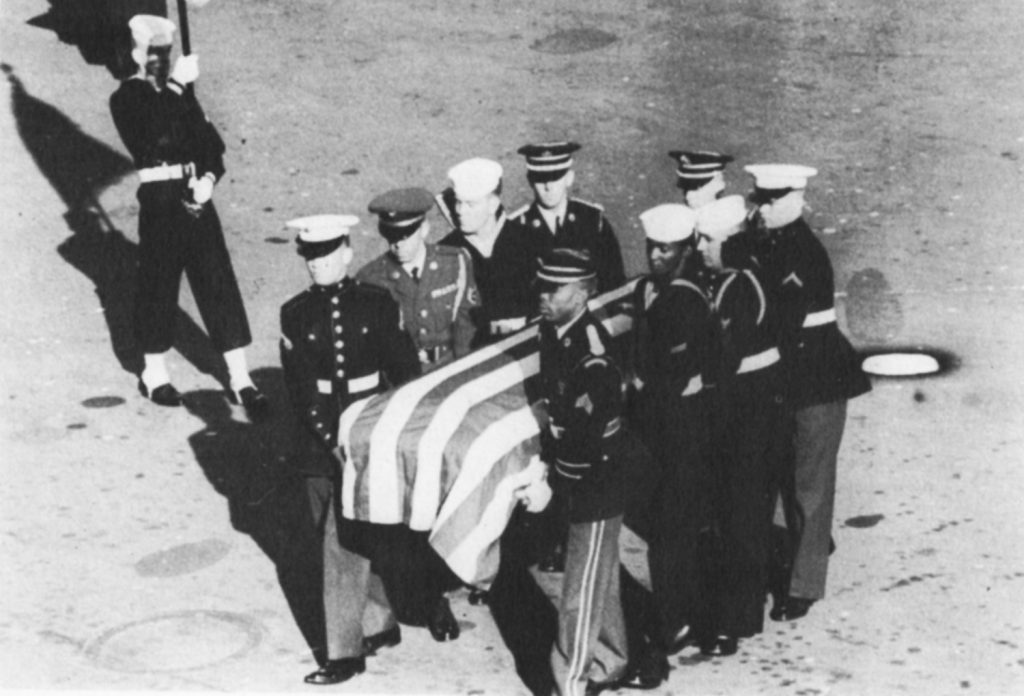 Servicemen carry the coffin