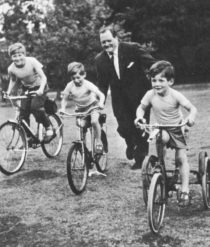Dimbleby and three children on bicycles