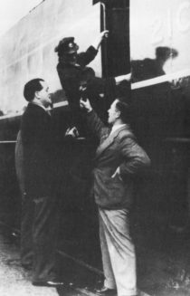 Dimbleby speaks to an engine driver who is climbing into his cab