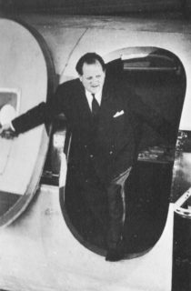 Dimbleby exits an aeroplane