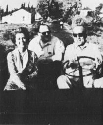 A woman, Dimbleby and a man in a jeep