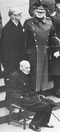 Eden and Slim stand behind a frail seated Attlee